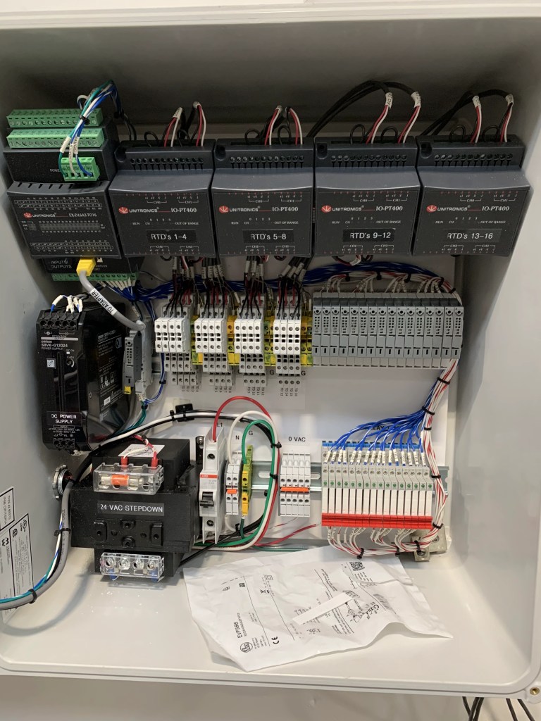 PLC modules and terminal wiring inside a beverage plant control cabinet